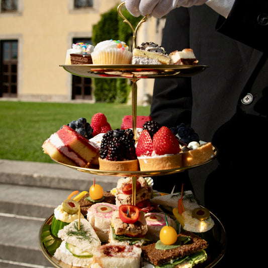 Butler holding a High Tea Three Tiered Tray of Sweets - Oheka Castle